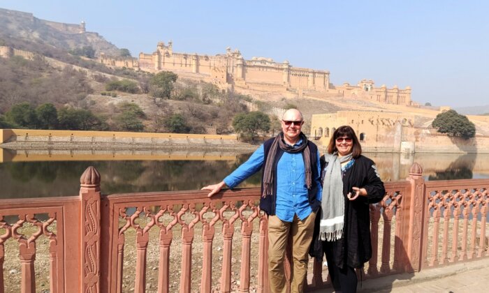 Couple standing Infront of a big fort in Jaipur