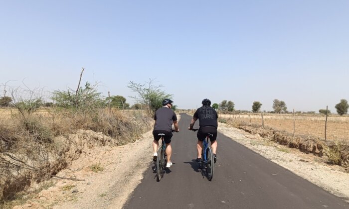 The tranquil rural landscape of Nimaaj, Rajasthan, featuring traditional architecture and expansive farmlands under a bright, clear sky, offering a glimpse into the rustic charm of this village.