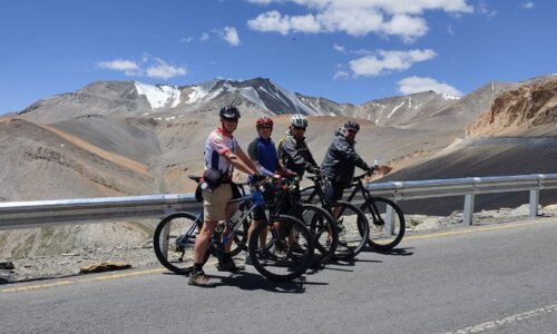 A rugged mountain landscape in Leh, Ladakh, with barren peaks and deep blue skies, capturing the stark beauty and remoteness of this Himalayan region.