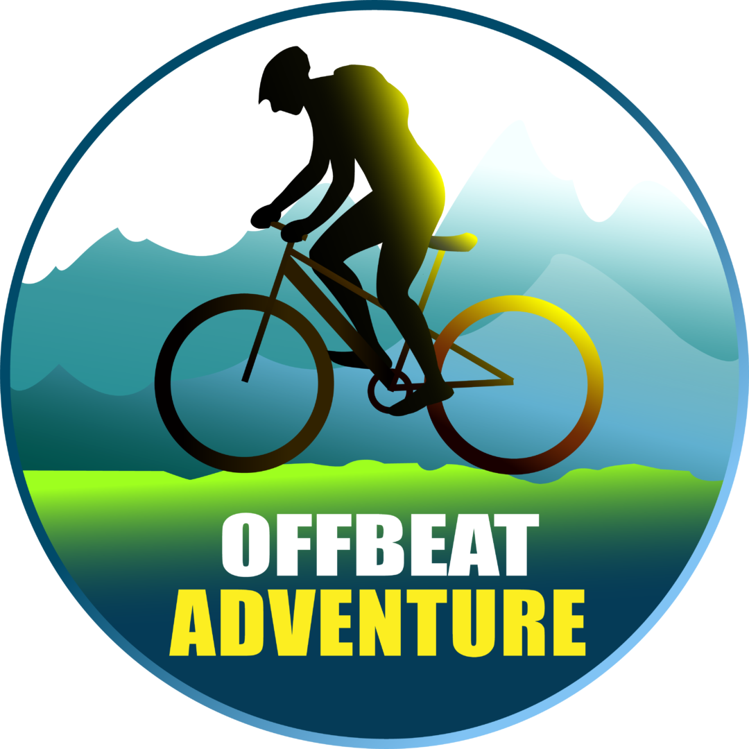 A silhouetted cyclist riding a bicycle against a scenic mountain landscape, with the text "Offbeat Adventure" prominently displayed.