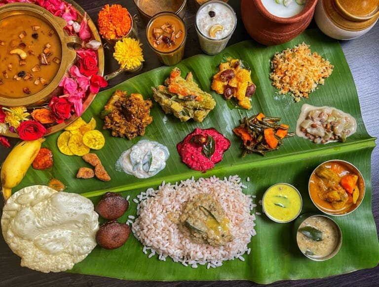 A banana leaf displaying a variety of authentic Kerala dishes, showcasing traditional meal presentation.
